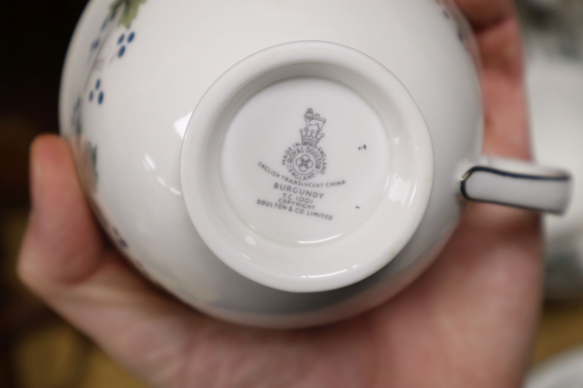 A Royal Doulton Burgundy pattern tea cups and saucers and a Doulton stoneware vase